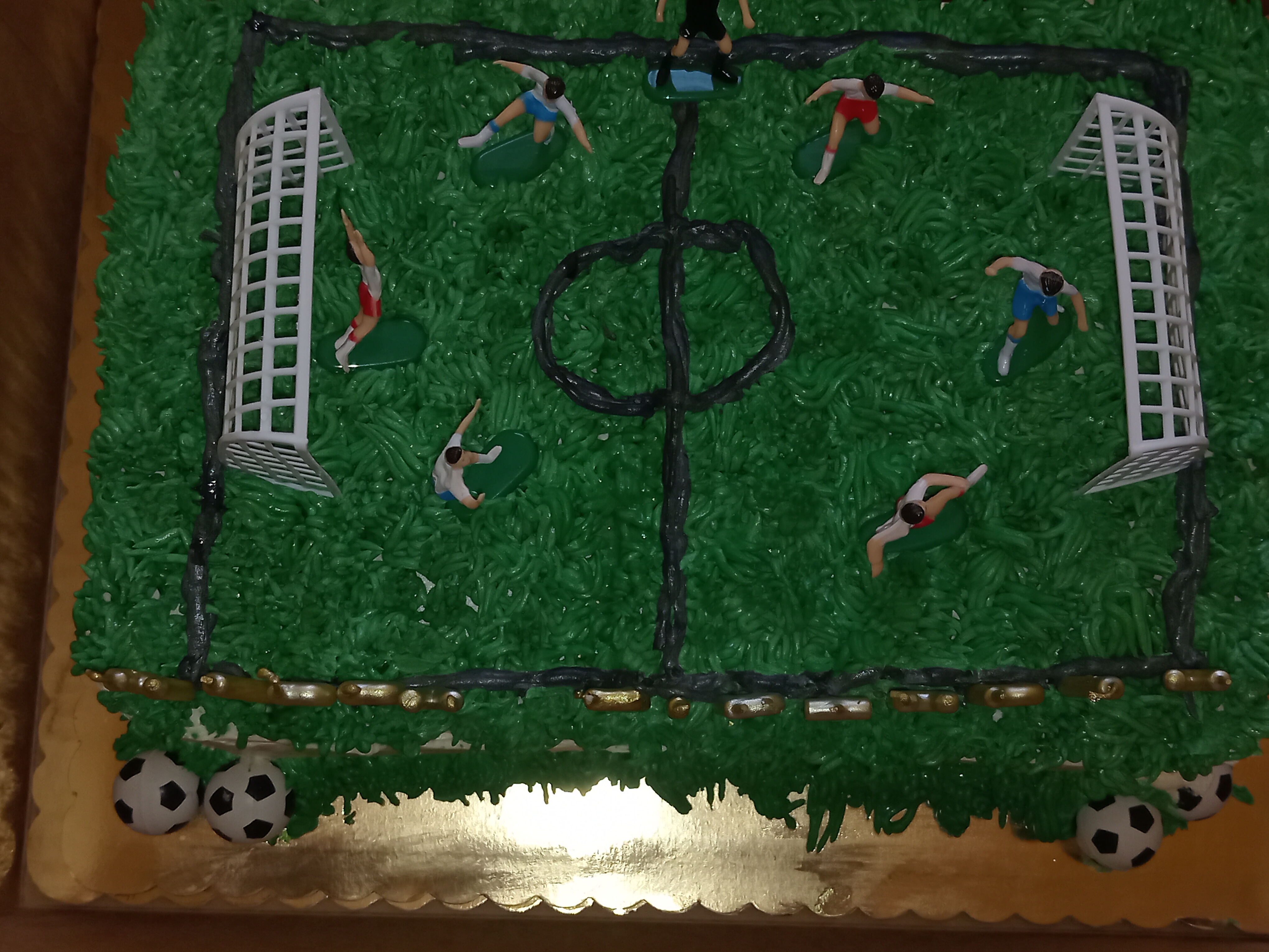 Epic soccer field cake with players and goal posts